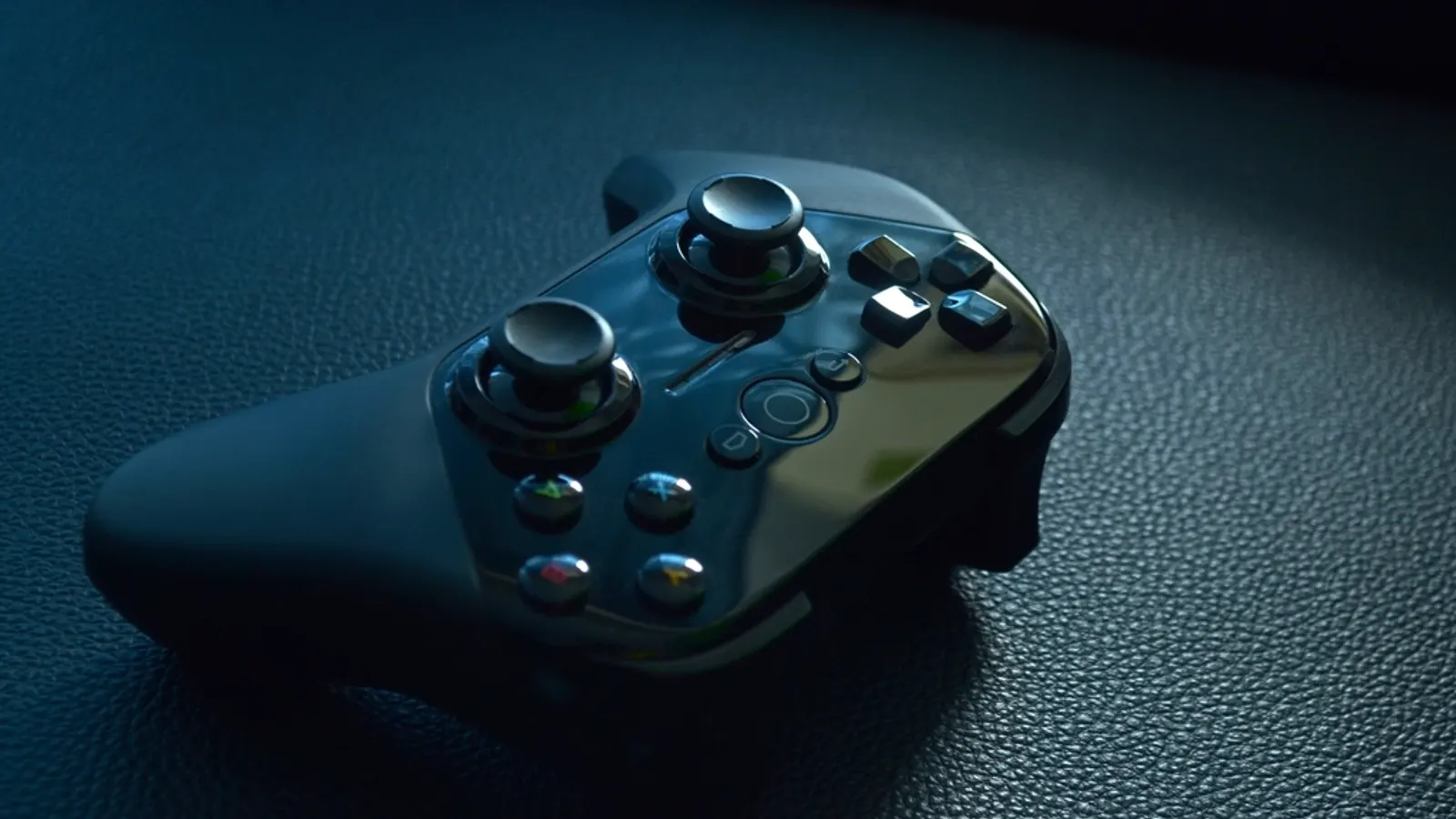 Game controller on a dark leather surface